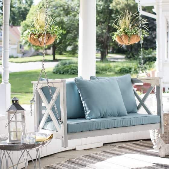 Front Porch with white swing suspended by chain link. Rustic Farmhouse or Coastal Beach outdoor decor